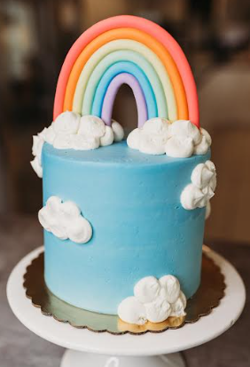 Premium Photo | Beautiful colorful children's birthday cake for a girl cake  with a rainbow clouds and a figurine of a girl the concept of a children's  holiday